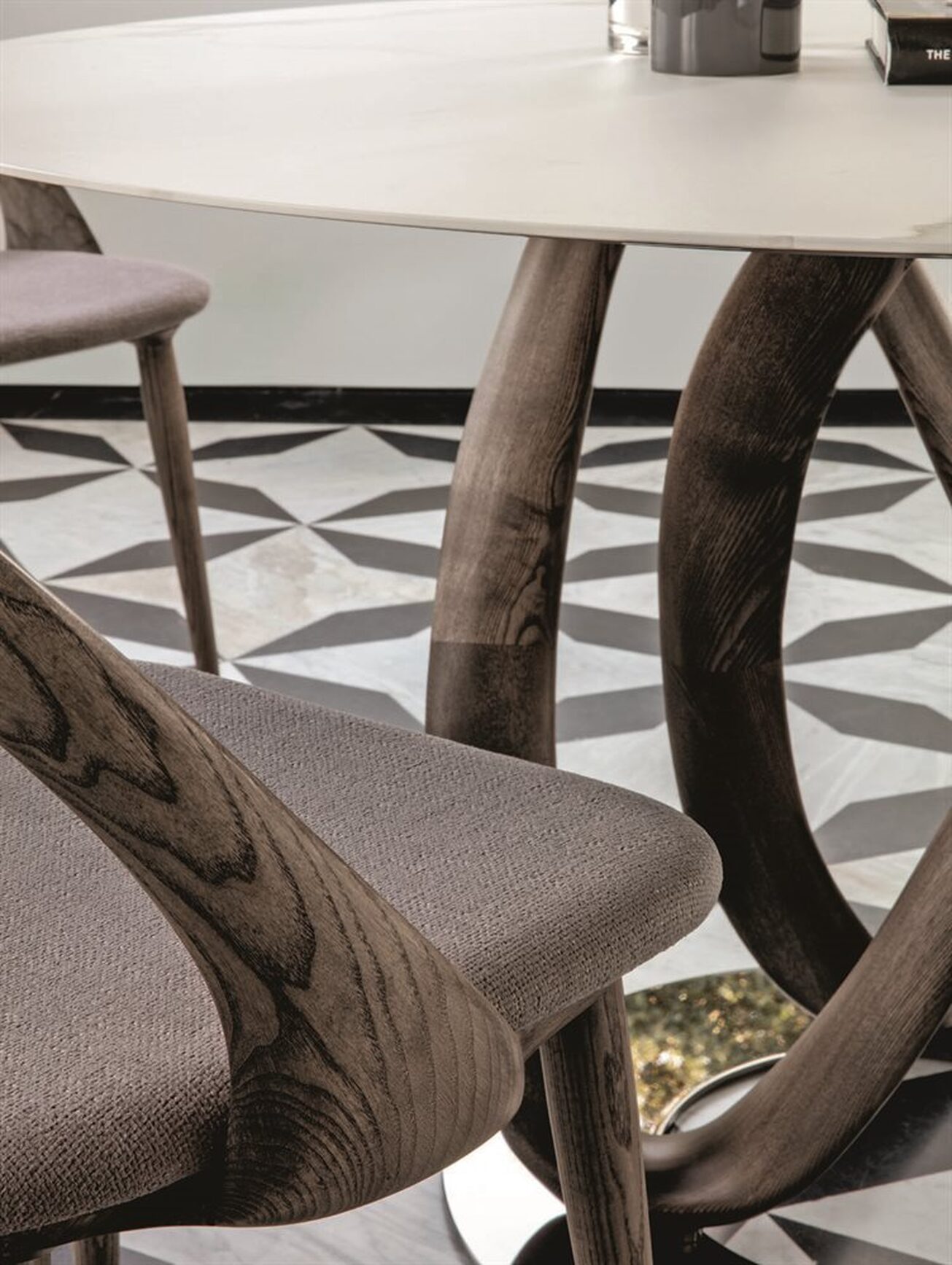 Leg detail of infinity table in calacatta walnut by Porada